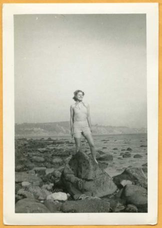 Woman Standing on Ocean Rocks